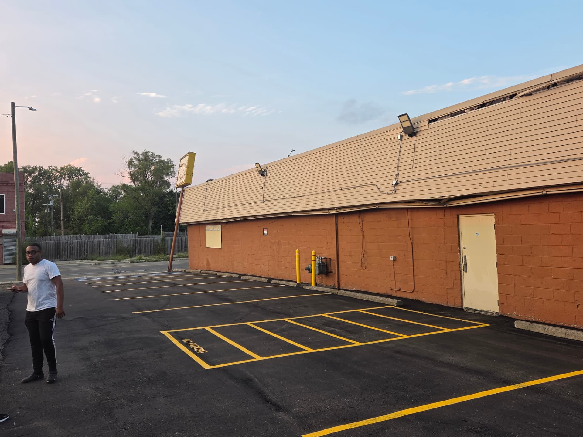 Wide view of a freshly striped parking lot with a hatched no-parking area