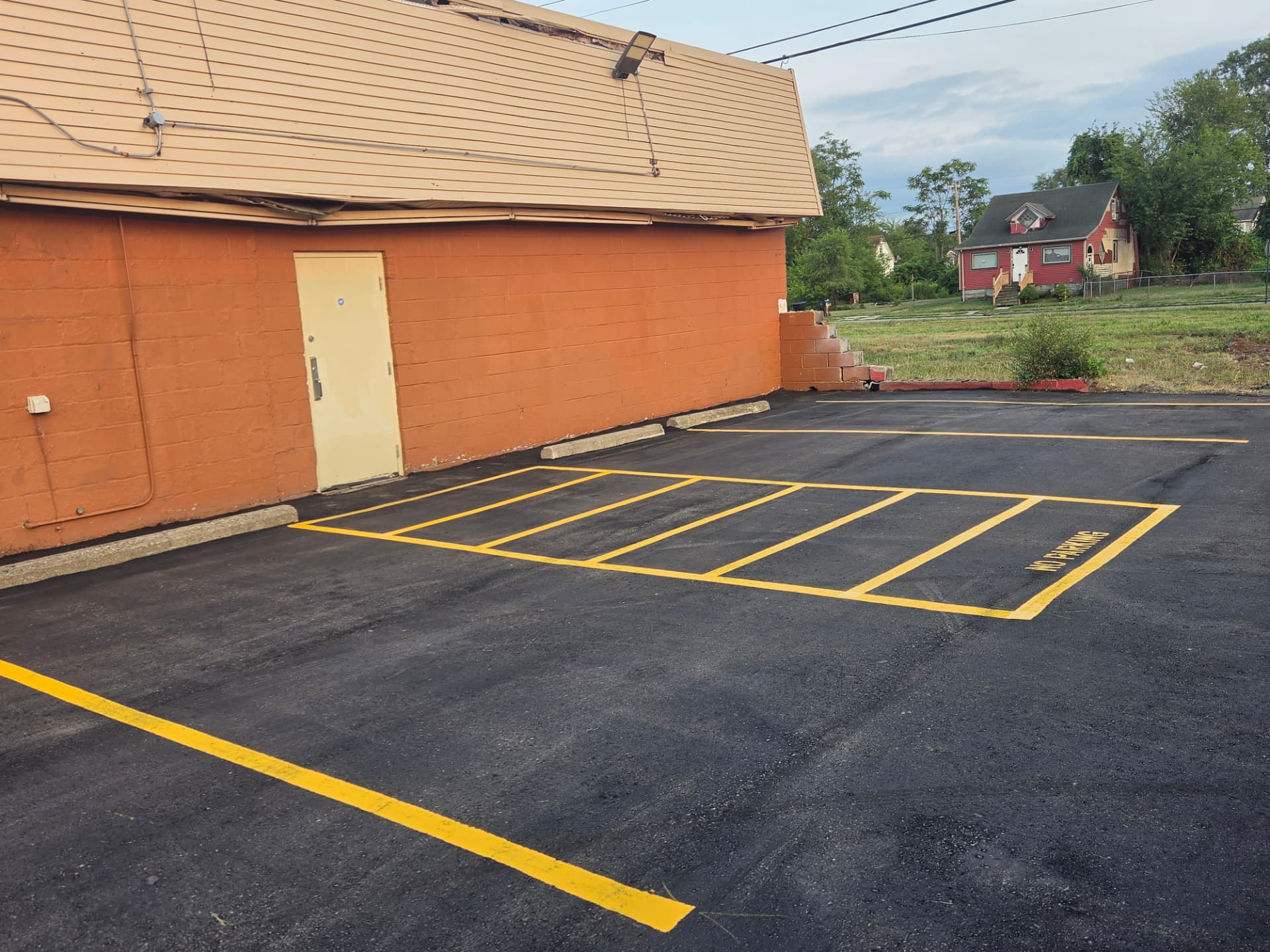 Yellow hatched no-parking zone and fresh stall lines after a full restripe